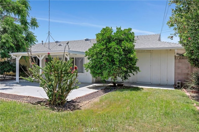 28656 Bradley Rd, Menifee, CA 92586 - back of house with a lawn, a patio, a shingled roof, and board and batten siding