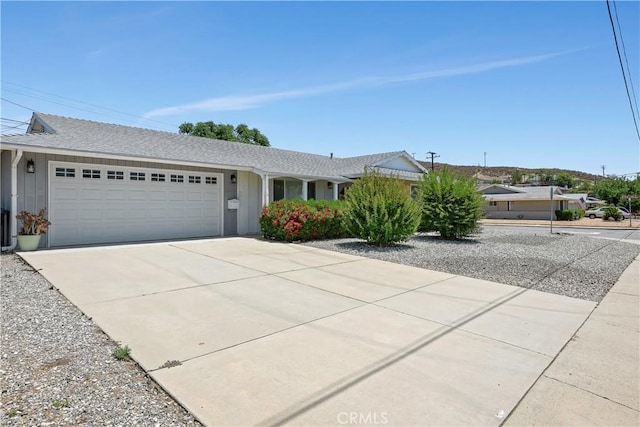 28656 Bradley Rd, Menifee, CA 92586 - ranch-style house featuring a garage, driveway, and roof with shingles
