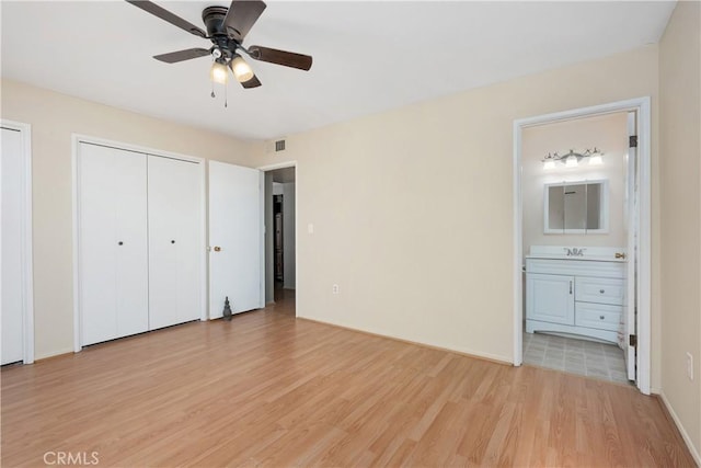 28656 Bradley Rd, Menifee, CA 92586 - unfurnished bedroom featuring light wood-type flooring, connected bathroom, and multiple closets