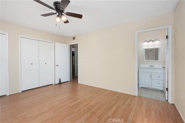 28656 Bradley Rd, Menifee, CA 92586 - unfurnished bedroom featuring light wood-type flooring, connected bathroom, and multiple closets