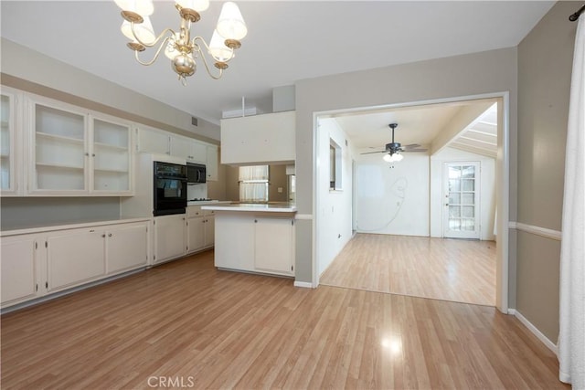 28656 Bradley Rd, Menifee, CA 92586 - kitchen featuring black appliances, light wood-style floors, a chandelier, glass insert cabinets, and light countertops