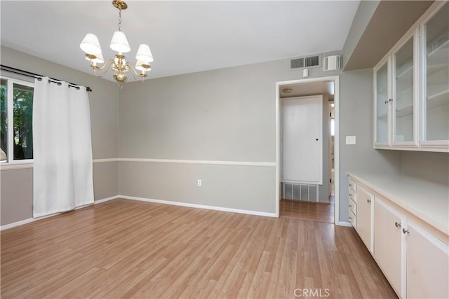 28656 Bradley Rd, Menifee, CA 92586 - unfurnished dining area featuring a chandelier and light wood-style floors