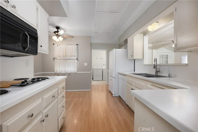 28656 Bradley Rd, Menifee, CA 92586 - kitchen featuring white appliances, separate washer and dryer, a ceiling fan, light countertops, and light wood-type flooring