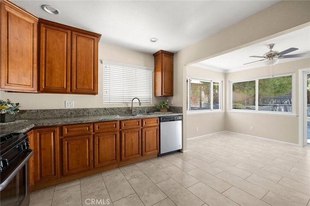 30314 Honeysuckle Hill Dr, Canyon Country, CA 91387 - kitchen with stainless steel appliances, brown cabinetry, ceiling fan, dark stone counters, and crown molding