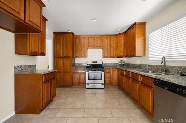 30314 Honeysuckle Hill Dr, Canyon Country, CA 91387 - kitchen featuring appliances with stainless steel finishes, brown cabinetry, stone counters, and recessed lighting