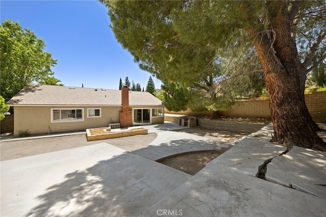 30314 Honeysuckle Hill Dr, Canyon Country, CA 91387 - rear view of house featuring a patio area, a fenced backyard, a chimney, and stucco siding