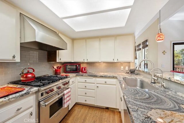5375 Rosario Ave, Atascadero, CA 93422 - kitchen featuring luxury stove, wall chimney exhaust hood, backsplash, and light wood-style floors