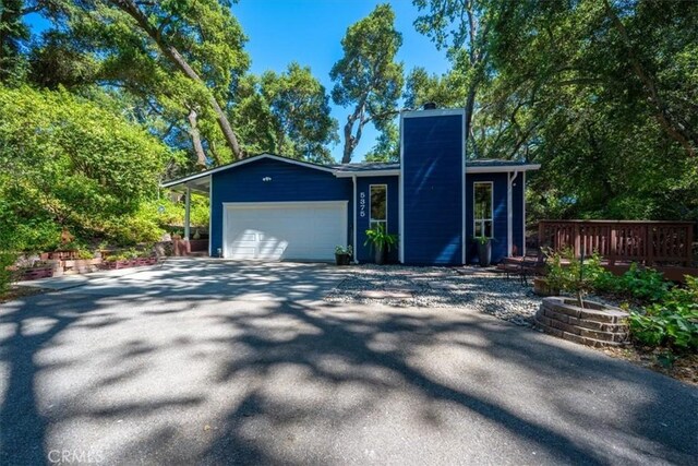5375 Rosario Ave, Atascadero, CA 93422 - view of front of home featuring a chimney, asphalt driveway, a garage, and a wooden deck