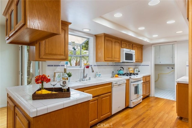 1716 Elm Ave, Manhattan Beach, CA 90266 - kitchen with white appliances, light wood-style floors, backsplash, recessed lighting, and brown cabinetry