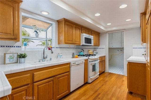 1716 Elm Ave, Manhattan Beach, CA 90266 - kitchen featuring white appliances, light wood-style flooring, backsplash, recessed lighting, and brown cabinetry