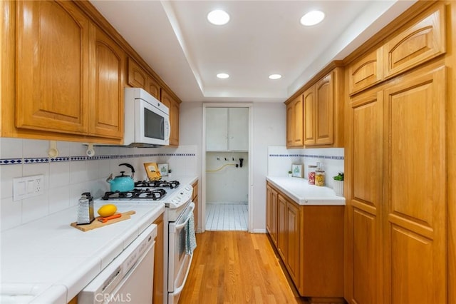 1716 Elm Ave, Manhattan Beach, CA 90266 - kitchen featuring white appliances, tile counters, decorative backsplash, light wood-style floors, and recessed lighting