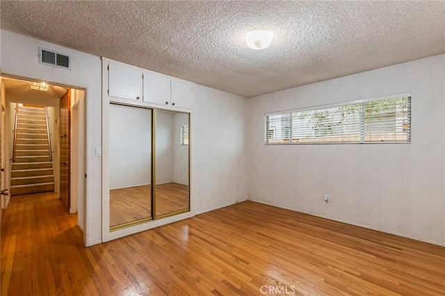1716 Elm Ave, Manhattan Beach, CA 90266 - unfurnished bedroom featuring light wood-style floors, a textured ceiling, and a closet