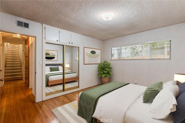 1716 Elm Ave, Manhattan Beach, CA 90266 - bedroom with a textured ceiling, light wood-style flooring, and a closet