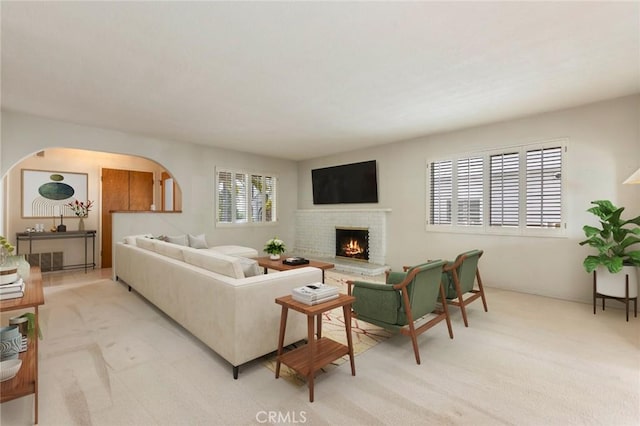 1716 Elm Ave, Manhattan Beach, CA 90266 - living area with a fireplace, arched walkways, and light colored carpet