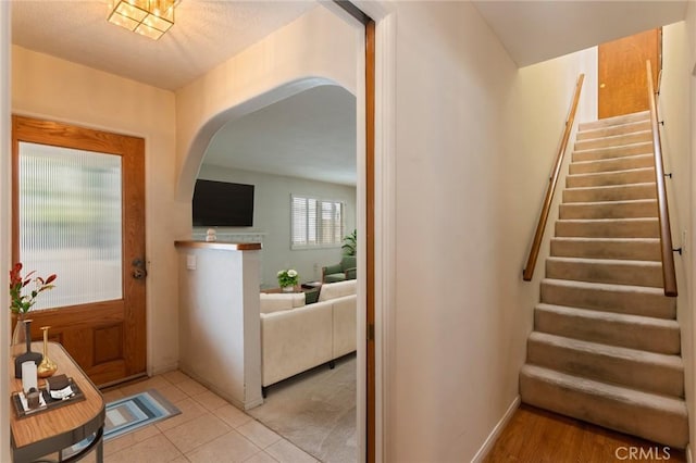 1716 Elm Ave, Manhattan Beach, CA 90266 - foyer entrance with arched walkways, stairway, and light tile patterned flooring