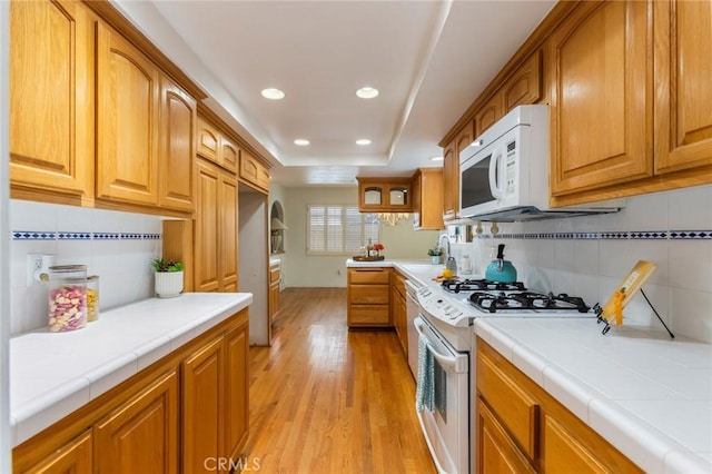 1716 Elm Ave, Manhattan Beach, CA 90266 - kitchen featuring white appliances, tile countertops, decorative backsplash, light wood-type flooring, and recessed lighting