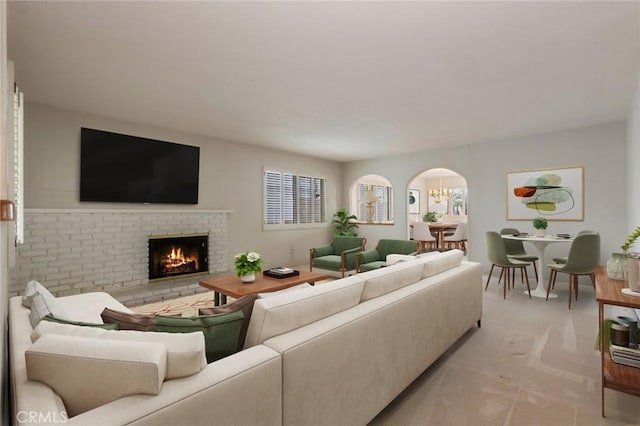 1716 Elm Ave, Manhattan Beach, CA 90266 - living area featuring arched walkways, a brick fireplace, and light colored carpet