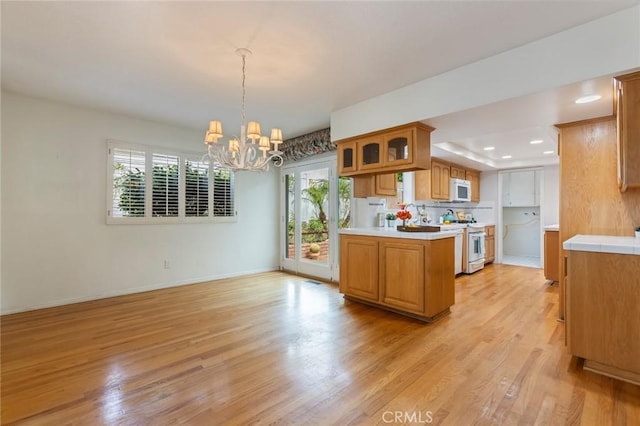 1716 Elm Ave, Manhattan Beach, CA 90266 - kitchen with white appliances, a chandelier, light countertops, light wood finished floors, and recessed lighting