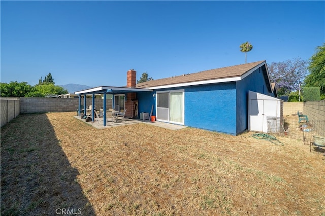 1722 Tiffany Ct, Ontario, CA 91762 - back of house featuring a patio, a fenced backyard, a chimney, and stucco siding
