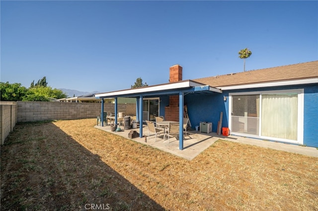 1722 Tiffany Ct, Ontario, CA 91762 - rear view of property featuring a chimney, a fenced backyard, stucco siding, and a patio area