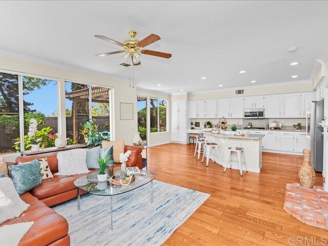 2381 Avenida Helecho, Carlsbad, CA 92009 - living area with crown molding, light wood-style floors, a ceiling fan, and recessed lighting