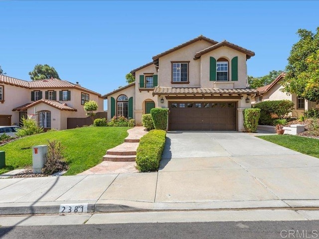 2381 Avenida Helecho, Carlsbad, CA 92009 - mediterranean / spanish-style house featuring stucco siding, a tile roof, an attached garage, driveway, and a front lawn