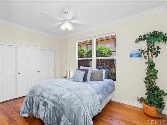 2381 Avenida Helecho, Carlsbad, CA 92009 - bedroom with wood finished floors, ornamental molding, a closet, and ceiling fan