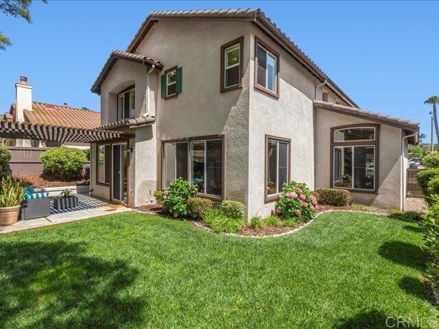 2381 Avenida Helecho, Carlsbad, CA 92009 - rear view of house featuring a yard, stucco siding, and a patio area
