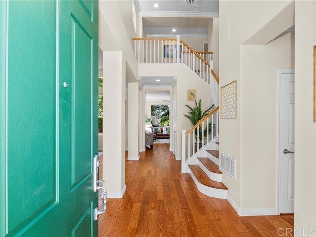 2381 Avenida Helecho, Carlsbad, CA 92009 - entrance foyer with crown molding, stairs, wood finished floors, a high ceiling, and recessed lighting