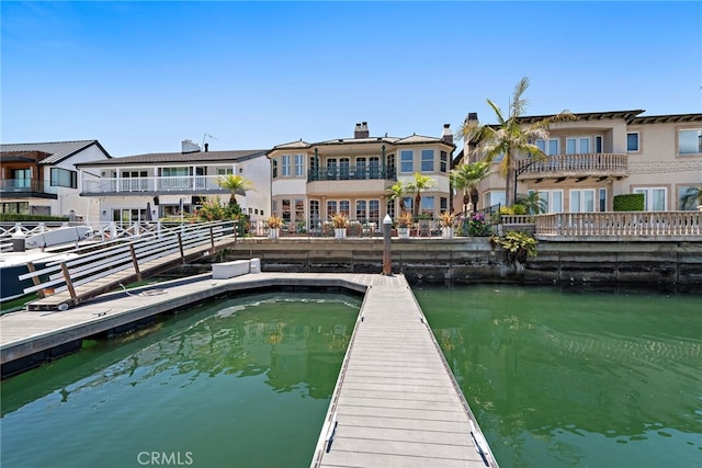 648 Harbor Island Dr, Newport Beach, CA 92660 - back of property with a water view and a chimney