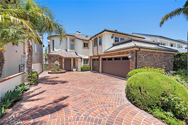 648 Harbor Island Dr, Newport Beach, CA 92660 - view of front of house with stucco siding, decorative driveway, and brick siding
