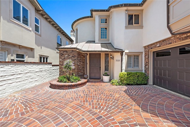 648 Harbor Island Dr, Newport Beach, CA 92660 - view of front of house with stucco siding, a standing seam roof, a garage, and brick siding
