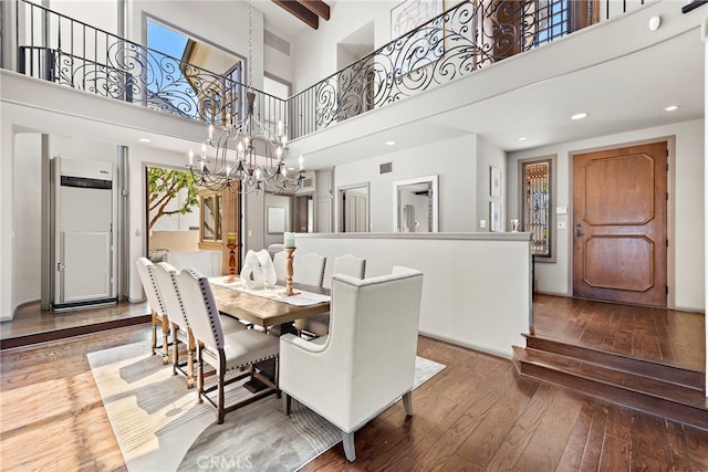 648 Harbor Island Dr, Newport Beach, CA 92660 - dining space with a towering ceiling, hardwood / wood-style floors, and a chandelier