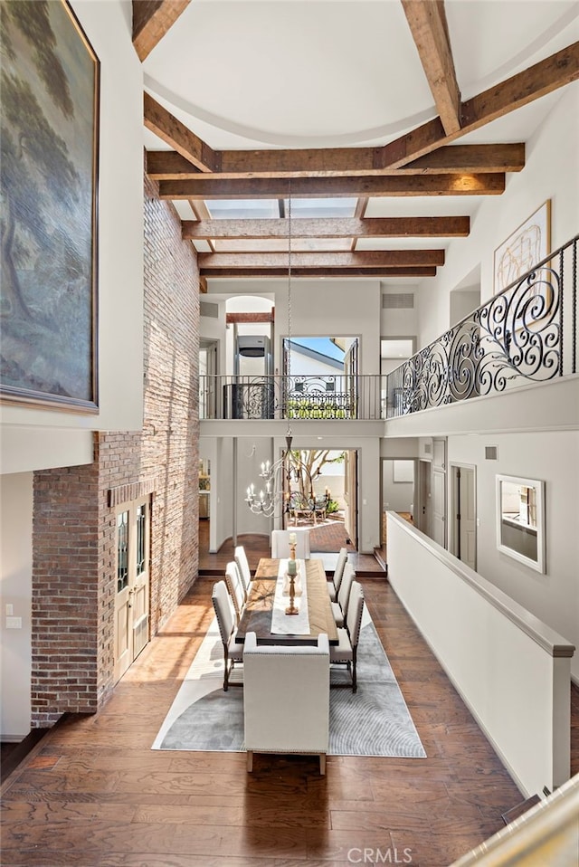 648 Harbor Island Dr, Newport Beach, CA 92660 - dining space featuring a high ceiling, beam ceiling, hardwood / wood-style flooring, stairway, and brick wall