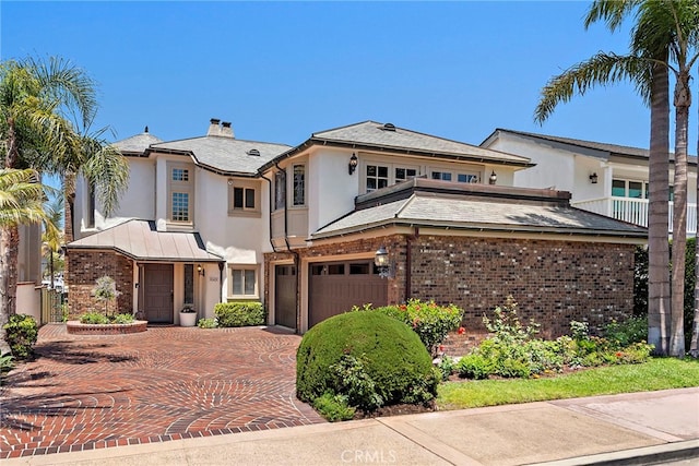 648 Harbor Island Dr, Newport Beach, CA 92660 - view of front of property with stucco siding, an attached garage, brick siding, and decorative driveway