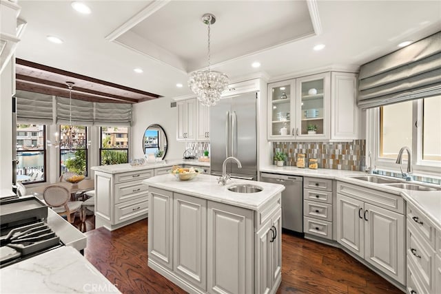 648 Harbor Island Dr, Newport Beach, CA 92660 - kitchen featuring stainless steel appliances, a center island with sink, decorative backsplash, dark wood finished floors, and decorative light fixtures