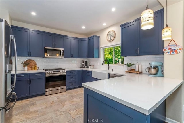 17138 Hickory Ridge Ct, Canyon Country, CA 91387 - kitchen with appliances with stainless steel finishes, blue cabinets, a peninsula, tasteful backsplash, and recessed lighting