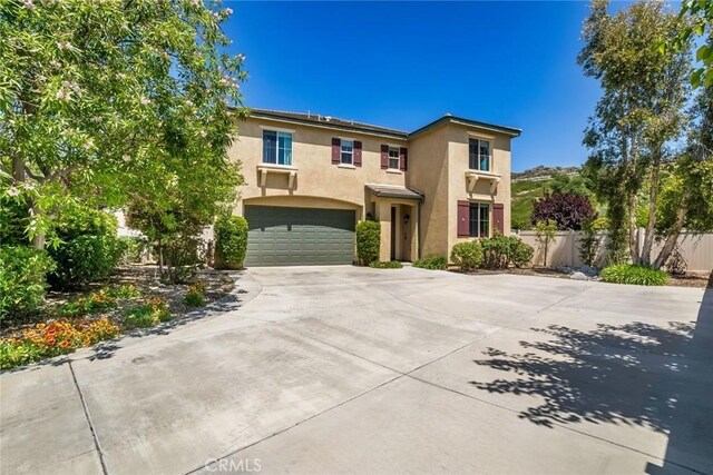 17138 Hickory Ridge Ct, Canyon Country, CA 91387 - view of front of house featuring stucco siding, concrete driveway, and a garage