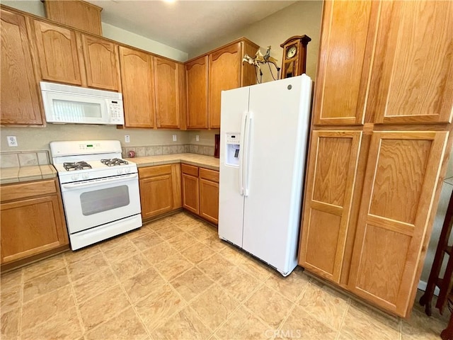 3803 Colma Ct, Merced, CA 95348 - kitchen with white appliances, tile countertops, and brown cabinetry
