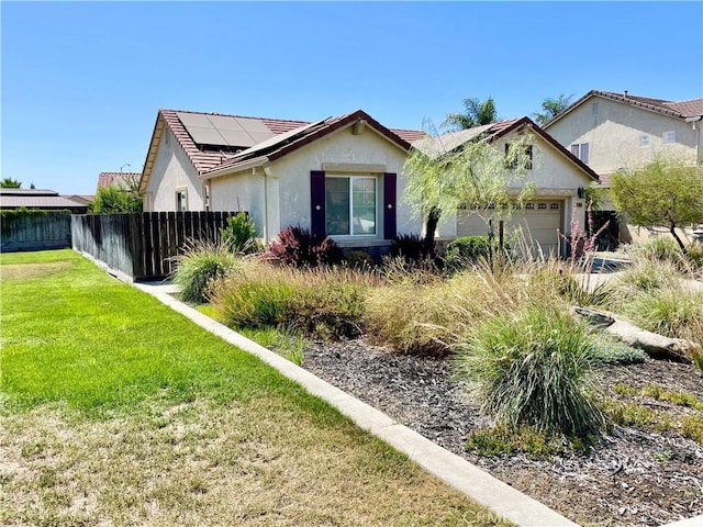 3803 Colma Ct, Merced, CA 95348 - view of front facade with stucco siding, roof mounted solar panels, an attached garage, and a tile roof