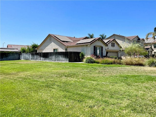 3803 Colma Ct, Merced, CA 95348 - view of front of property with stucco siding, roof mounted solar panels, and a garage