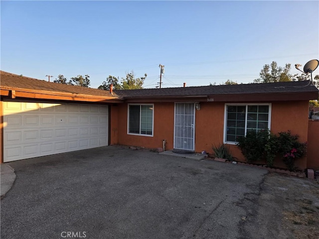 3608 Wagoner Ln, Corona, CA 92879 - ranch-style home with asphalt driveway, stucco siding, a garage, and a shingled roof