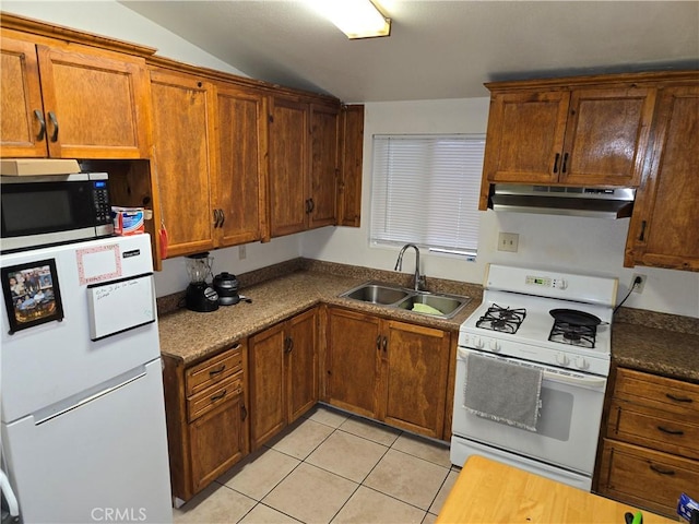 3608 Wagoner Ln, Corona, CA 92879 - kitchen with under cabinet range hood, white appliances, light tile patterned floors, vaulted ceiling, and brown cabinets