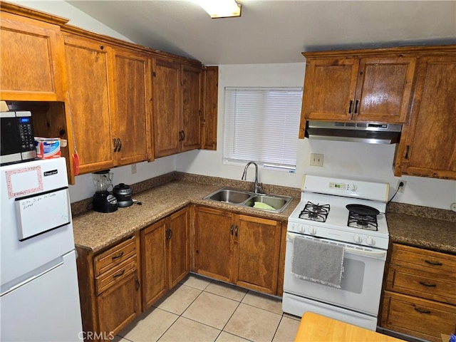3608 Wagoner Ln, Corona, CA 92879 - kitchen featuring under cabinet range hood, white appliances, light tile patterned floors, brown cabinets, and vaulted ceiling