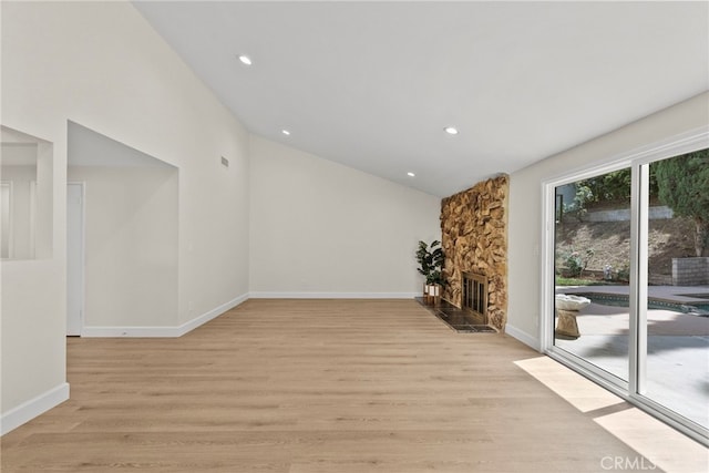12847 Winthrop Ave, Granada Hills, CA 91344 - unfurnished living room with a fireplace, light wood finished floors, vaulted ceiling, and recessed lighting
