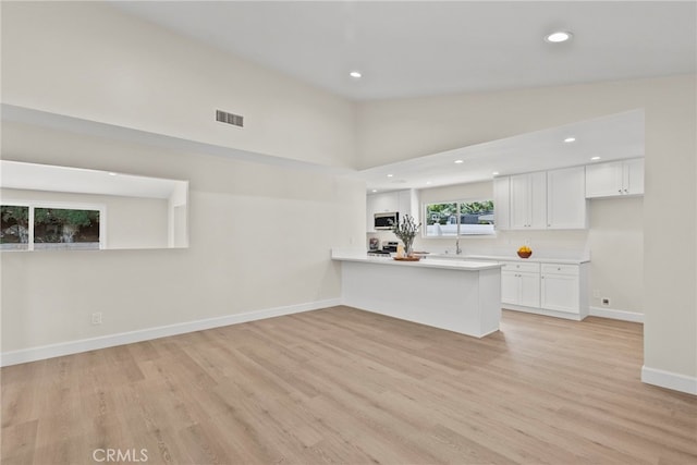 12847 Winthrop Ave, Granada Hills, CA 91344 - unfurnished living room with light wood-style floors, recessed lighting, and a high ceiling