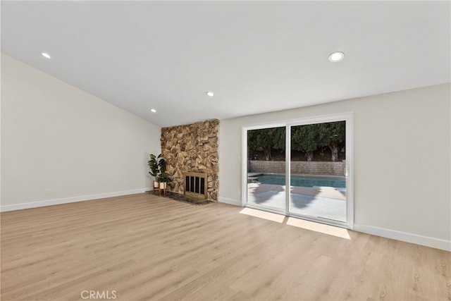 12847 Winthrop Ave, Granada Hills, CA 91344 - unfurnished living room featuring light wood-style floors, a stone fireplace, and recessed lighting
