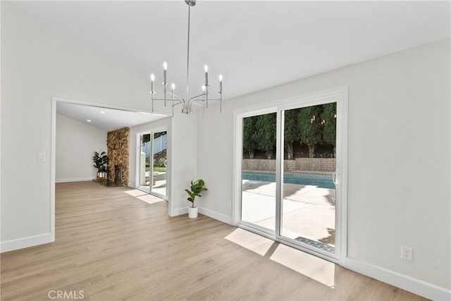 12847 Winthrop Ave, Granada Hills, CA 91344 - unfurnished dining area with light wood-style floors and a chandelier