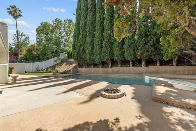 12847 Winthrop Ave, Granada Hills, CA 91344 - view of swimming pool featuring a patio, a fenced backyard, an outdoor fire pit, and a diving board