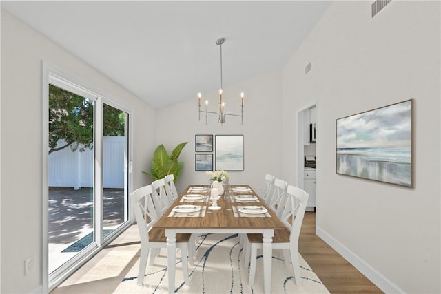 12847 Winthrop Ave, Granada Hills, CA 91344 - dining space with vaulted ceiling, a chandelier, and light wood-style floors